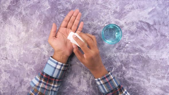 Man's Hand with Medicine Spilled Out of the Pill Container