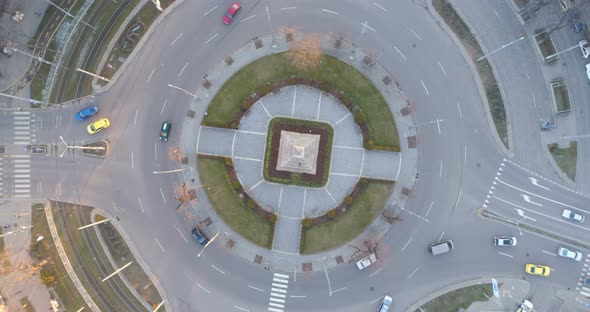 Cityscape at Sunset with Peaceful Traffic in Roundabout