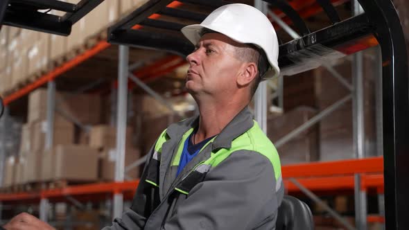 Forklift Driver in Hard Hat During Work in Storage