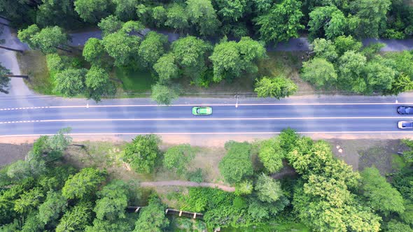 Aerial view of highway in city. Cars crossing interchange overpass. 