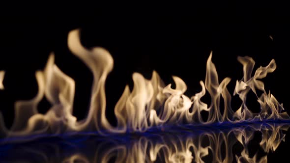 Flammable Liquid or Petrol Stains on Black Reflective Background Flash and Ignite