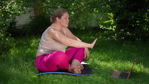 Side View Beautiful Plussize Sportswoman Waving Talking at Laptop Video Chat Smiling Sitting on