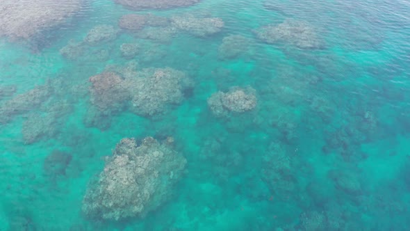 Stunning Coral Reef Under The Shallow Blue Water In Natadola Bay In Fiji - drone shot