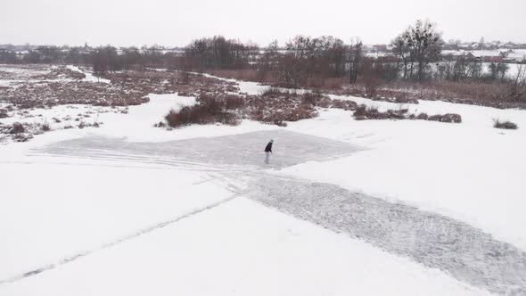 Ice skating in winter outdoors on frozen lake