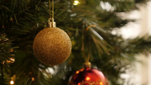 Gold color bauble with sequins hanged on the branch 4K 2160p 30fps UltraHD footage - Golden ornament