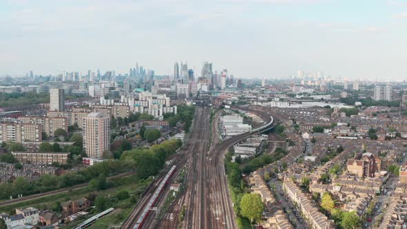 dolly forward drone shot of busy British rail train tracks towards London city centre