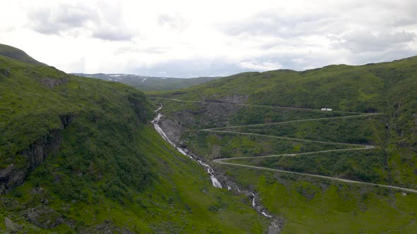 Holesvingane hairpin turns on mountain pass, drone view of Sendefossen falls