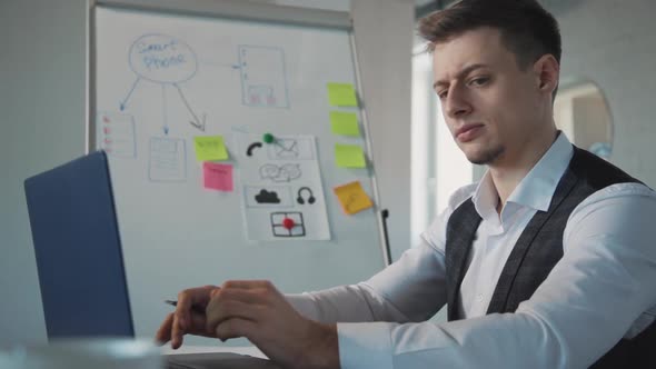 Concentrated Business Man Ux Designer Working on Laptop in Office