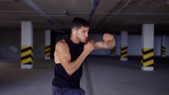 Boxer Does Shadow Boxing in Underground Parking