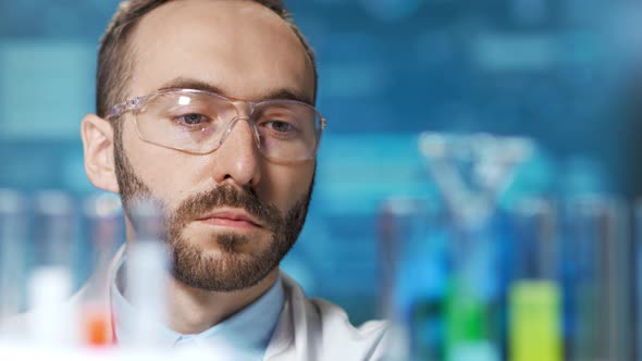 Closeup Male Microbiology Science Doctor Working with Reactive at Futuristic Blue Lights Background