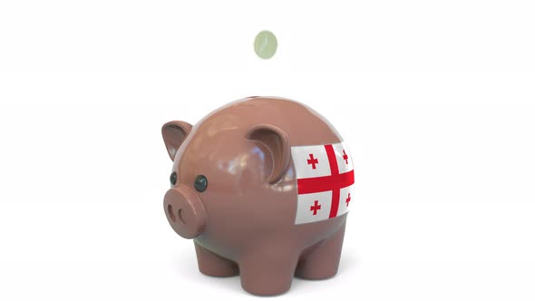 Putting Money Into Piggy Bank with Flag of Georgia