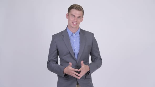 Happy Young Handsome Businessman in Suit Smiling