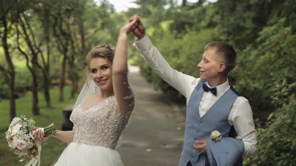 Newlyweds. Caucasian Groom with Bride in the Park. Wedding Couple. Happy Family