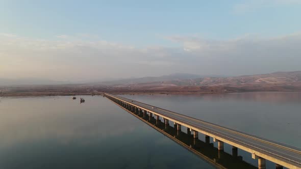 Traffic flow on the long bridge and its reflection in the river