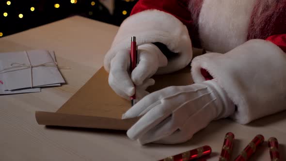 Close Up Hands Santa Claus Writes Congratulations Children on New Year Holidays