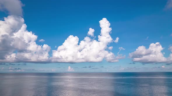 Stunning white clouds scenery hyperlapse above calm open ocean water alt