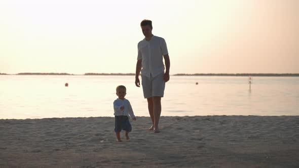 Toddler Boy Walking Near His Father on Tropical Island Beach