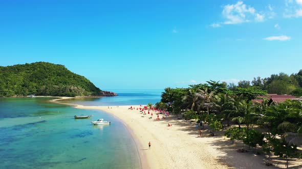 Luxury birds eye tourism shot of a white paradise beach and turquoise sea background in 4K