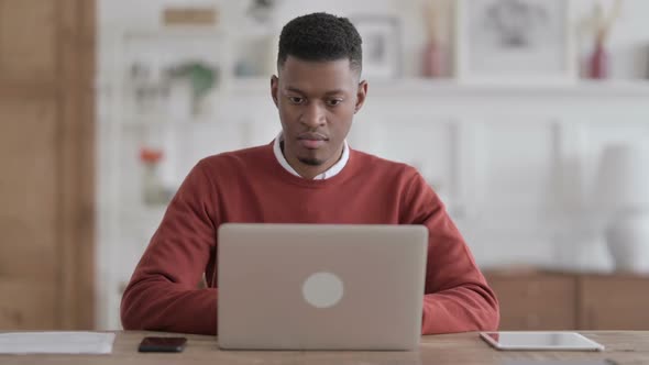 African Man Closing Laptop Standing Up, Going Away