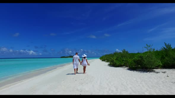 Man and woman tan on relaxing sea view beach wildlife by aqua blue lagoon with white sand background