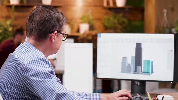 Architect in the Office Working on Design for the New City Skyscrapers