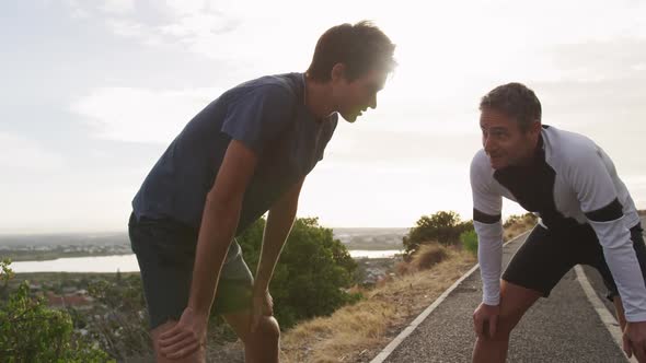 Father and young adult son enjoying outdoor activities together