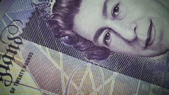 Fifty British Pound paper banknote in close up macro view dolly shot.