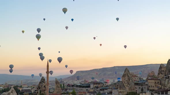 Zoom in timelapse of hot air balloons flights at sunrise in Goreme, Cappadocia, Turkey