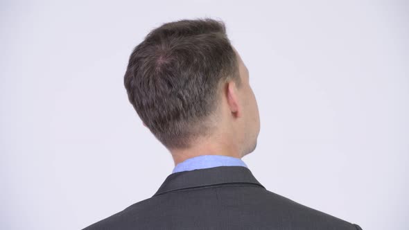 Rear View Head Shot of Businessman Looking for Something