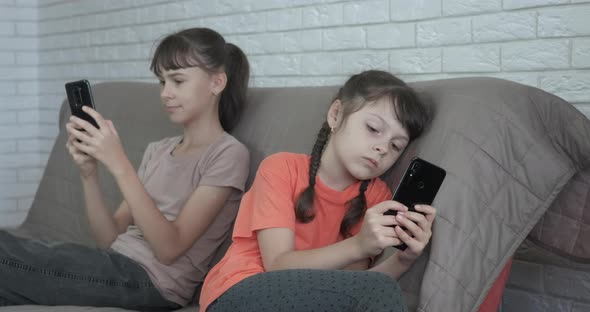 Sisters with Smartphones in Internet