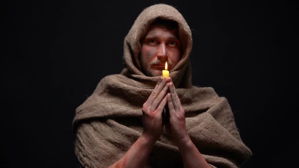 Poor Sick Man in Robe Holding Candle and Praying God, Asking for Help, Belief