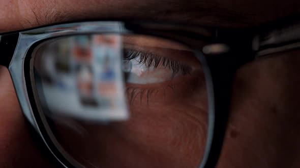 Man in Glasses Looking on the Monitor and Surfing Internet