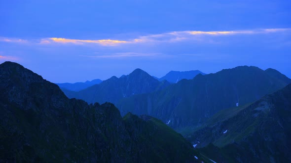 Time Lapse of a Silhouetted Blue Mountains and Horizon at Fagaras Mountains