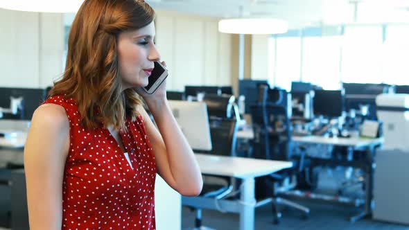 Female executive talking on mobile phone