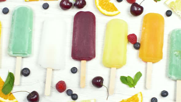 multicolored icicle with fresh fruit on white background