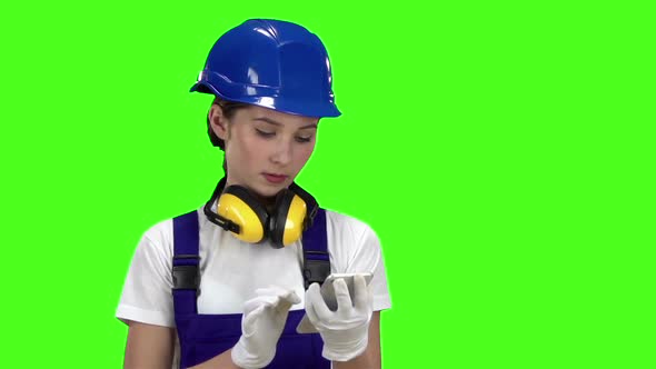 Engineer Prints a Message on the Phone To His Customer. Green Screen. Slow Motion
