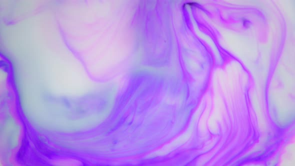 Ink in Water. Purple Ink Reacting in Water Creating Abstract Background. alt