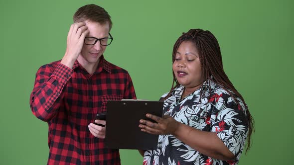 Overweight African Woman and Young Scandinavian Man Together Against Green Background