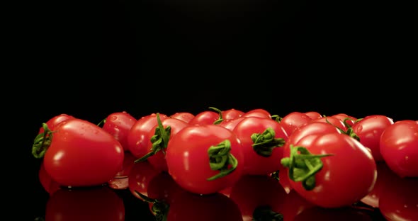 Red Tomatoes on Black Glossy Background