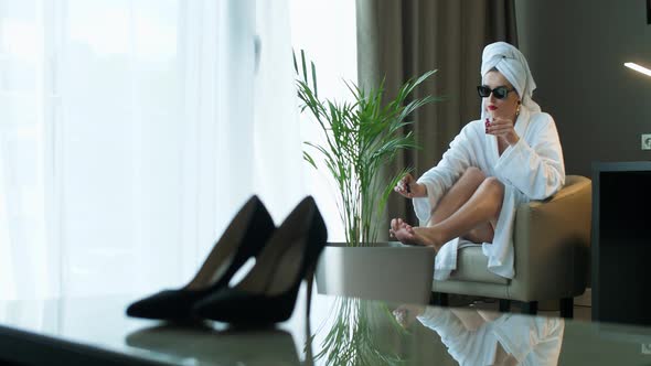 Girl in a Bathrobe in a Hotel