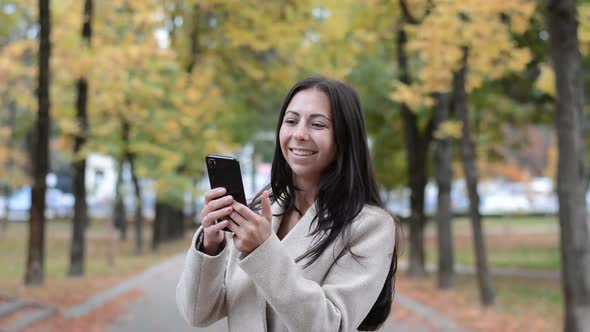 Young Woman Portrait with Black Hair Writing s Ms in the Autumn Park