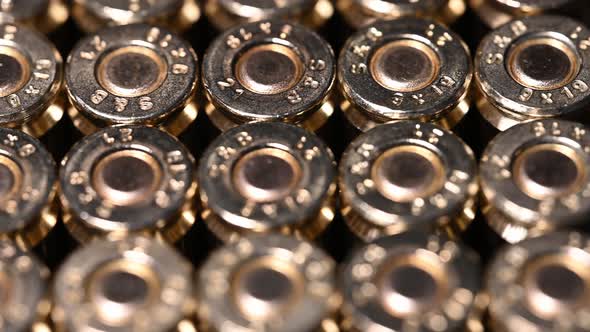 very slow close-up of 9mm bullets for pistol, personal protection weapon, or rifle