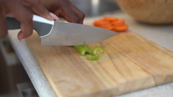 Crop black woman preparing healthy salad for lunch