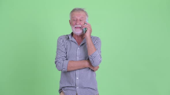 Happy Senior Bearded Man Talking on the Phone