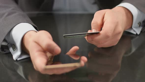 Top Manager Hands Typing Credit Card Number on Smart Phone