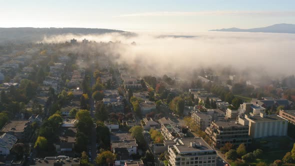 Stunning aerial view of fog covering an idyllic Vancouver community