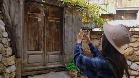 Tourist Woman Taking Photo of Old Door