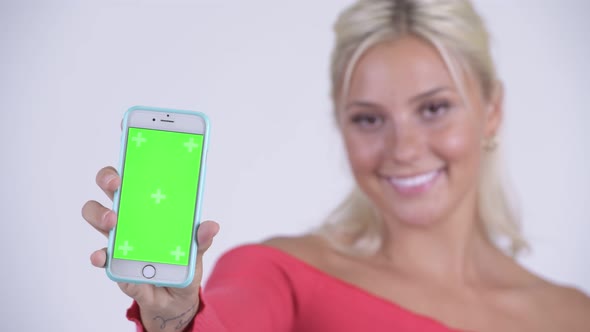 Face of Happy Young Beautiful Blonde Woman Showing Phone