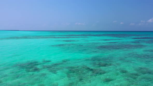 Tropical fly over abstract view of a white sandy paradise beach and turquoise sea background in high