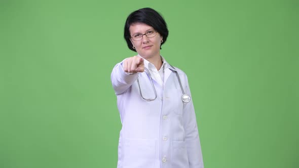 Beautiful Woman Doctor with Short Hair Pointing at Camera